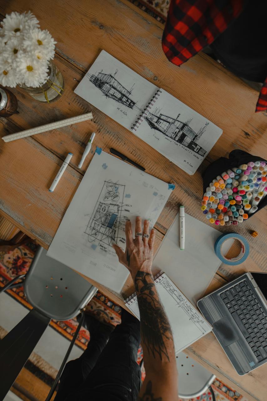 Architect reviewing a renovation project at a desk with a laptop