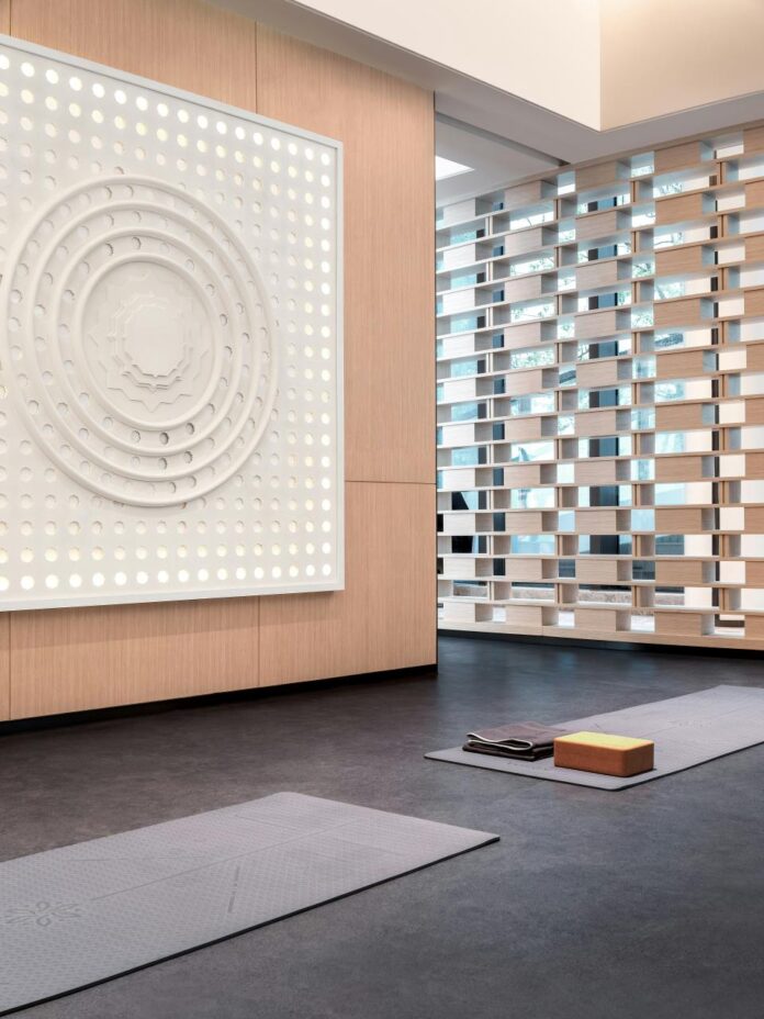 Yoga mats and props arranged in a bright modern wellness room